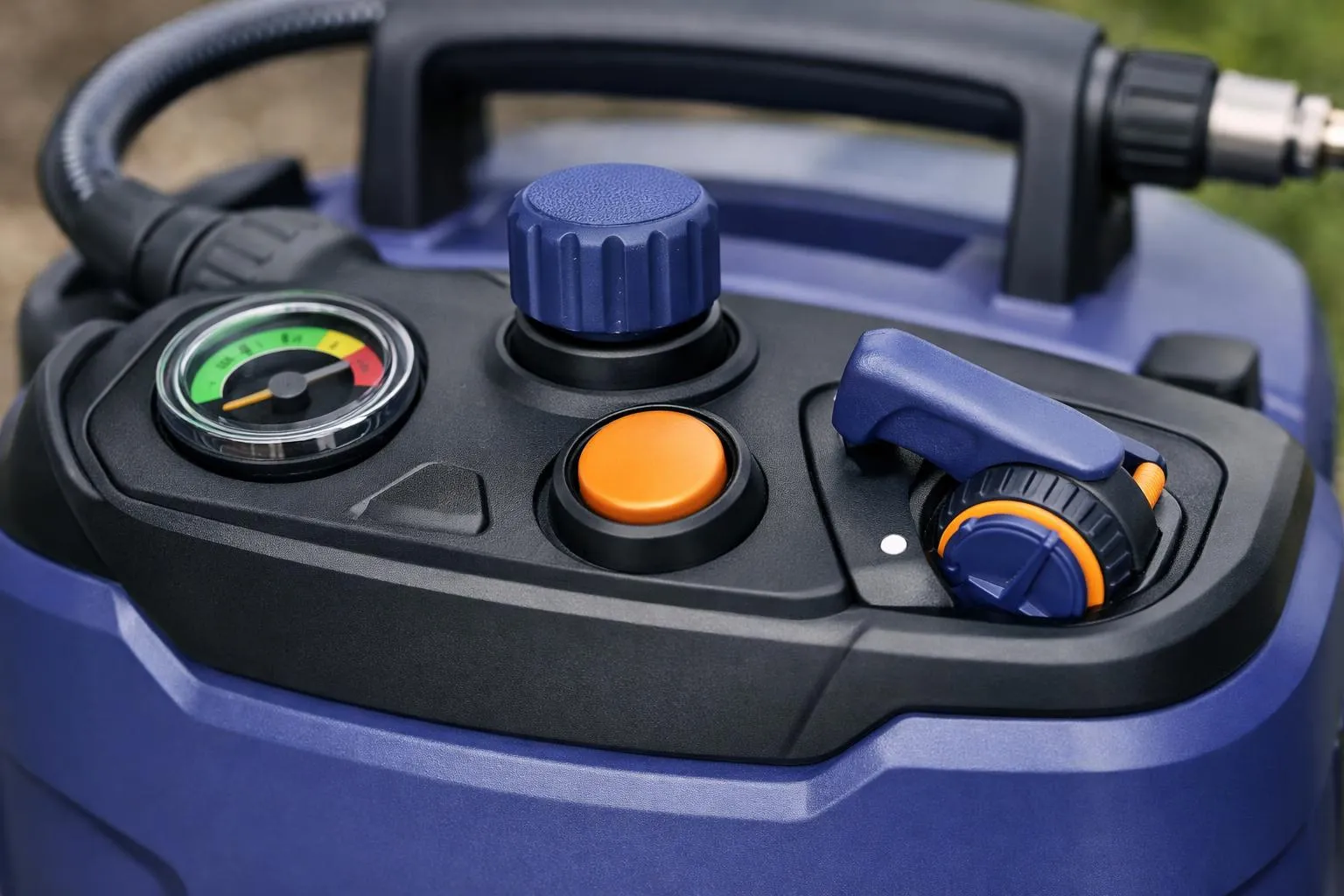Pressure gauge, control knobs, and hose on a blue device.